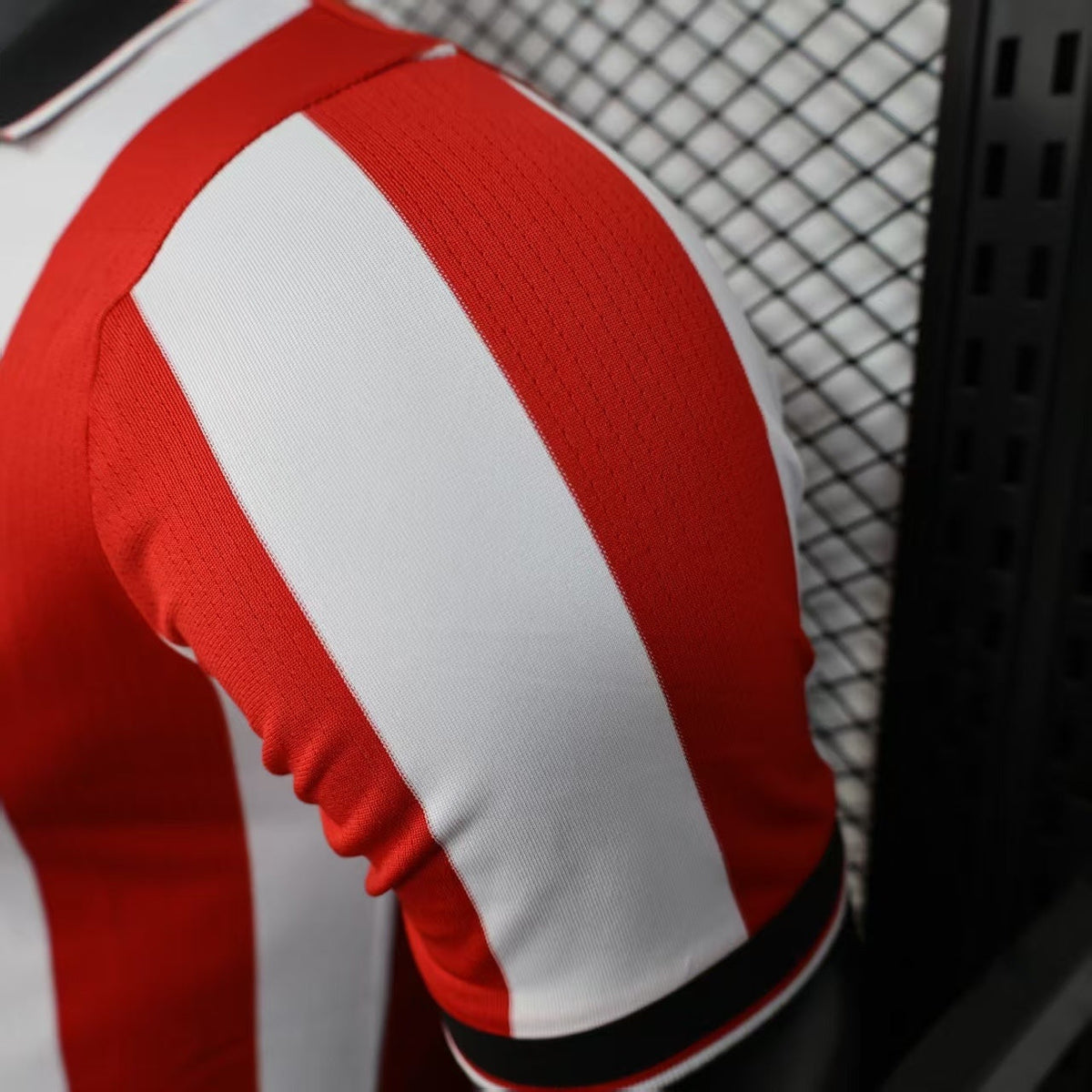 2025/26 Athletic Bilbao Home Player Version Jersey - Red White Vertical Stripe Body Black V-Neck Collar Black Sleeve Cuff Trim - Castore Logo - Athletic Club Official Shield Crest - Kutxabank - Men's