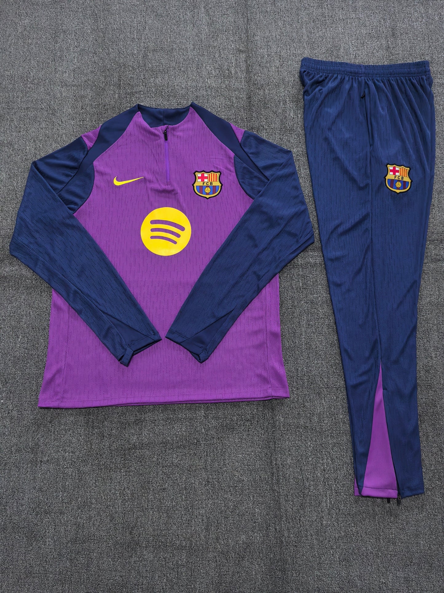 2025/26 FC Barcelona Kids Training Tracksuit Set - Purple Body Navy Blue Sleeve & Shoulder Panels - Quarter-Zip - Yellow Nike Swoosh - FCB Crest - Spotify Yellow Sponsor - Navy Blue Pants Purple Side Panels