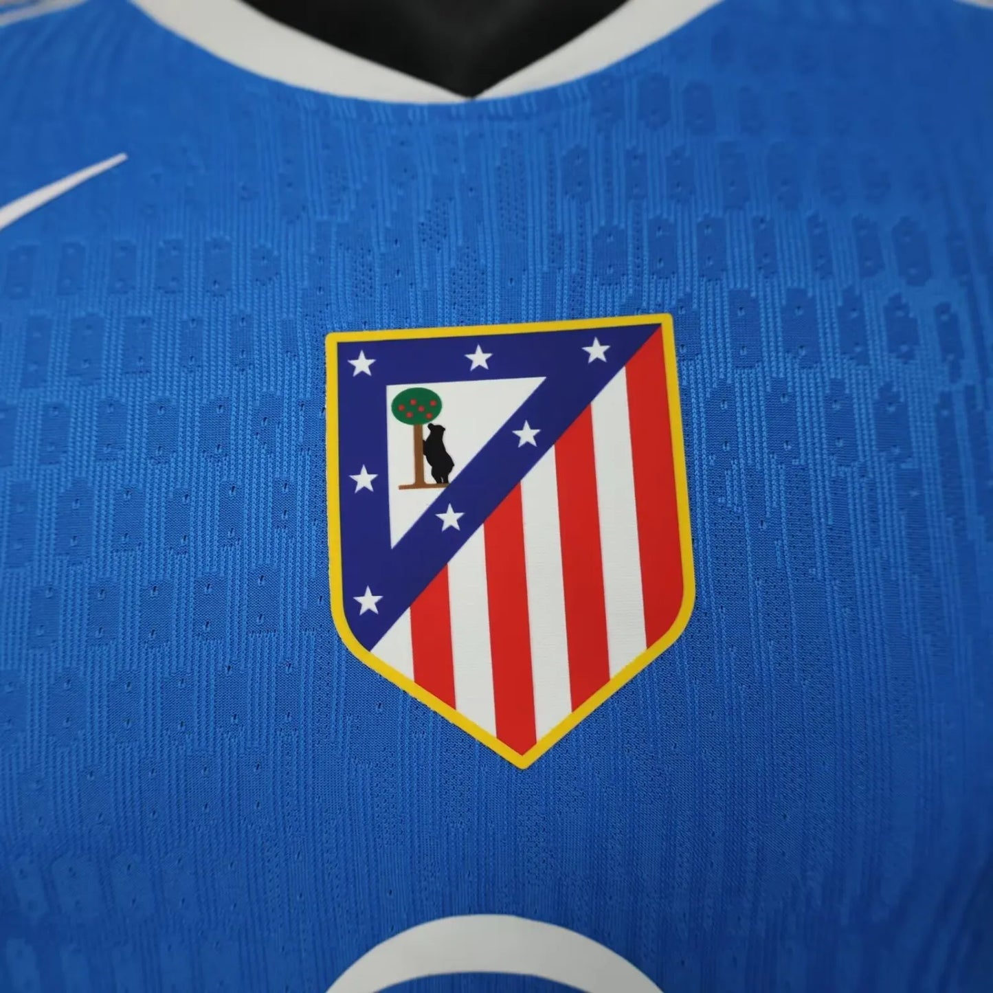 2025/26 Atlético Madrid Away Player Version Jersey - Sky Blue Body All-Over Subtle Diamond Tonal Texture White V-Neck Collar White Trim Red Diagonal Slash Left Sleeve Cuff Accent - White Swoosh - Atlético Madrid Official Shield Crest - Riyadh Air - Men's