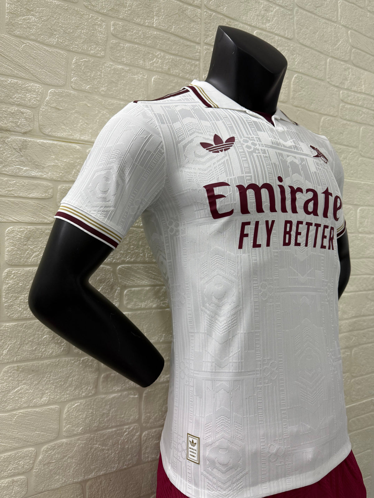 2025/26 Arsenal Third Player Version Jersey - White Body All-Over Subtle Tonal Graphic Texture Deep Maroon Polo Collar Gold Cream Stripe Trim Deep Maroon Sleeve Cuff Trim - Originals Trefoil - Arsenal Cannon Crest - Emirates Fly Better