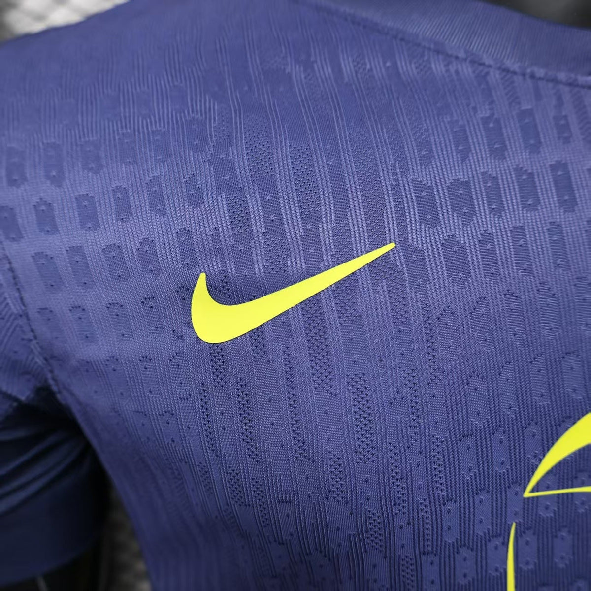 2025/26 Atlético Madrid Away Player Version Jersey - Deep Purple-Navy Body All-Over Subtle Geometric Tonal Texture Deep Purple-Navy V-Neck Collar - Nike Volt Yellow-Green Swoosh - Atlético Madrid Official Shield Crest Volt Yellow-Green