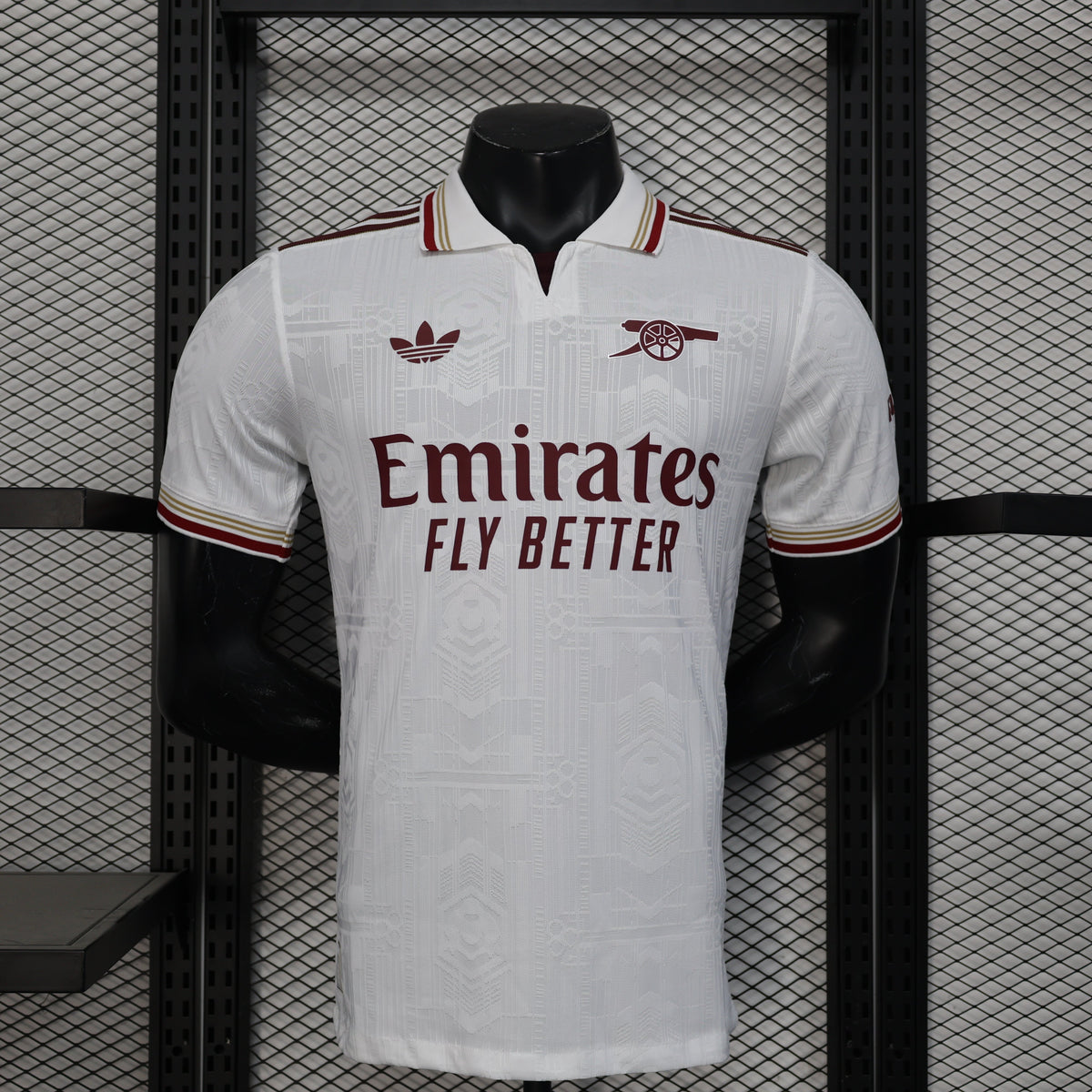 2025/26 Arsenal Away Player Version Jersey - White Body All-Over Tonal Emirates Stadium Architectural Line Emboss Pattern Deep Maroon Polo Collar Multi-Stripe Gold Red White Trim -Arsenal Cannon Crest - Emirates Fly Better