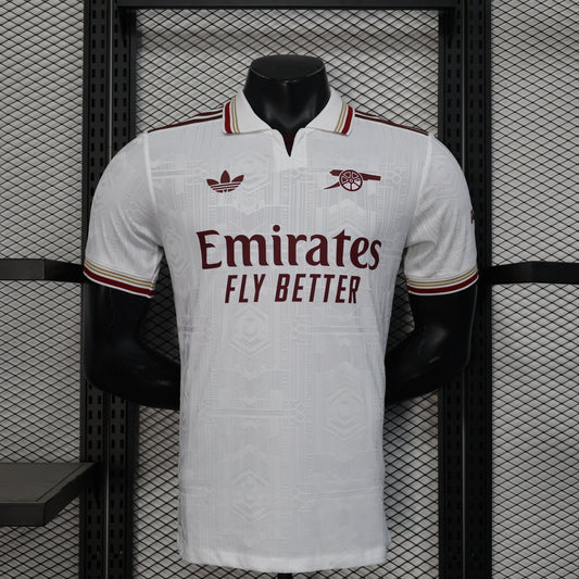2025/26 Arsenal Away Player Version Jersey - White Body All-Over Tonal Emirates Stadium Architectural Line Emboss Pattern Deep Maroon Polo Collar Multi-Stripe Gold Red White Trim -Arsenal Cannon Crest - Emirates Fly Better